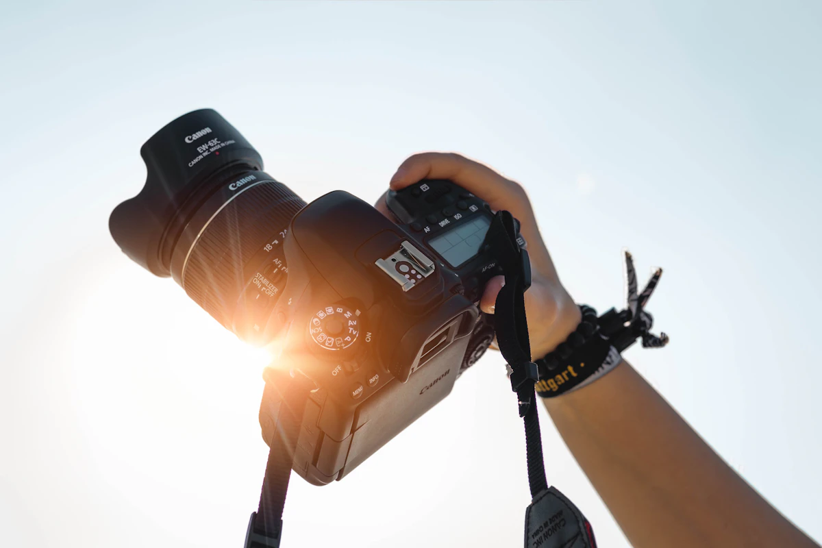 Lead photographer framing a shot through camera lens